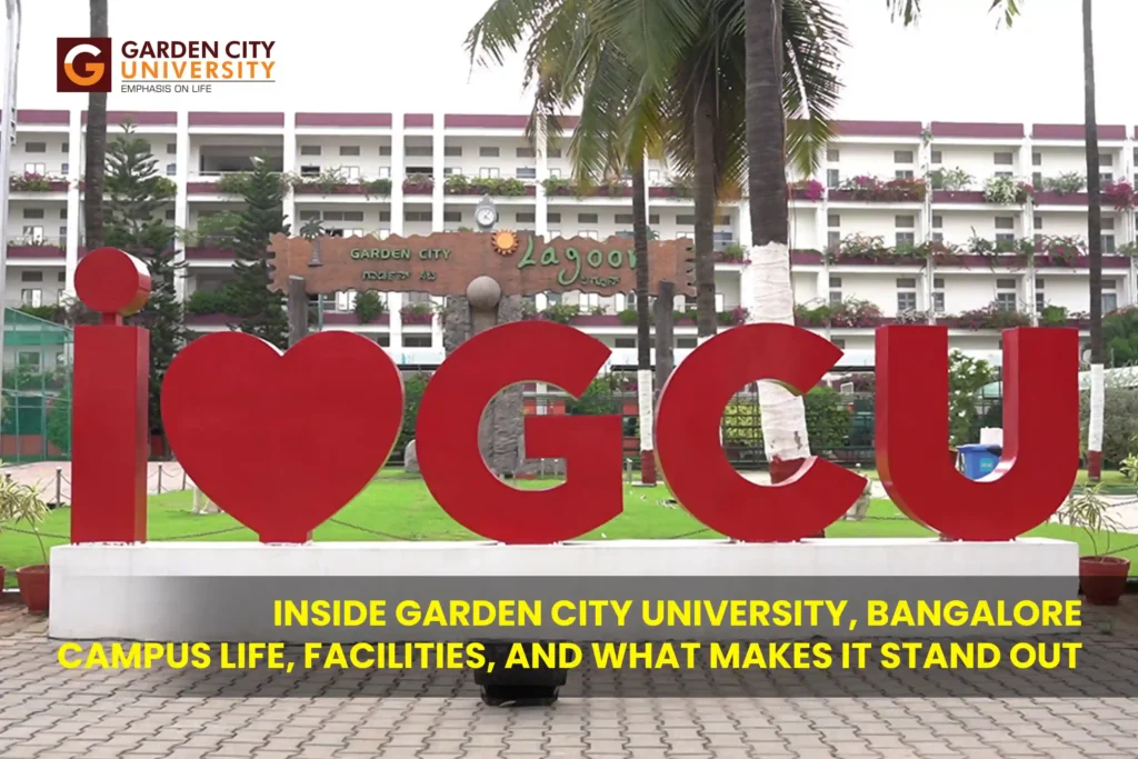 A large red installation on a paved campus walkway reading 'I ❤️ GCU' with green lawns and a multi-story campus building in the background. Text at the bottom reads: Inside Garden City University, Bangalore: Campus Life, Facilities, and What Makes It Stand Out